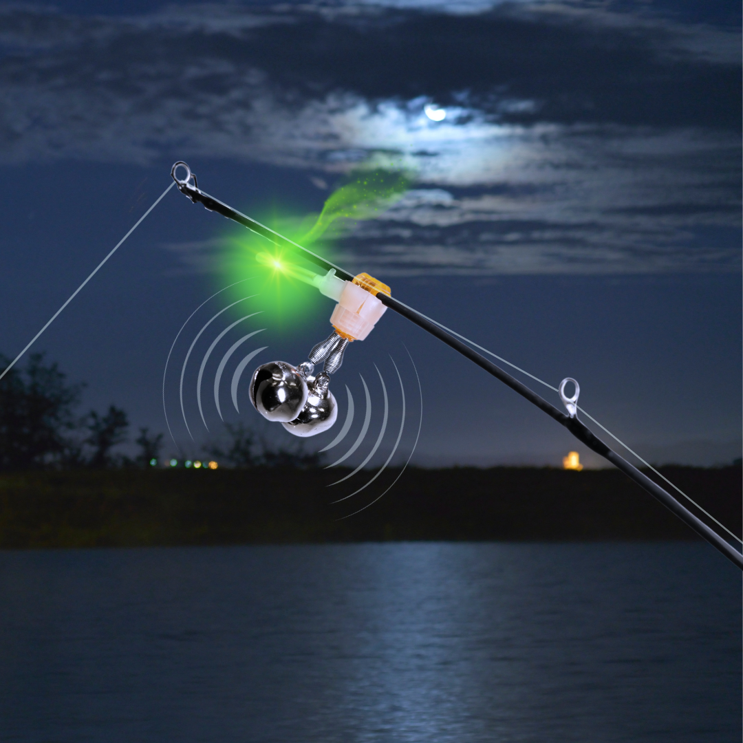 Fishing bite alert. Fishing rod is flexing with glowing light stick give visual indication and the bells sounding a fish alarm.